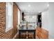 Stylish dining room featuring hardwood floors, exposed brick, and modern lighting at 3028 N Gilpin St, Denver, CO 80205
