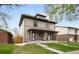 Charming two-story home with covered porch and well-manicured lawn at 3028 N Gilpin St, Denver, CO 80205