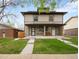 Charming two-story home with covered porch and well-manicured lawn at 3028 N Gilpin St, Denver, CO 80205