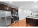 Modern kitchen featuring stainless steel appliances, dark cabinets, and breakfast bar at 3028 N Gilpin St, Denver, CO 80205