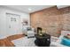 Bright living room with exposed brick, plush seating, and modern decor at 3028 N Gilpin St, Denver, CO 80205