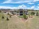 A beautiful, large home showcasing a spacious outdoor entertainment space and well-kept yard at 5195 Raintree Cir, Parker, CO 80134