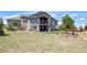 A home with a large backyard featuring a seating area, spacious patio, and beautiful landscaping at 5195 Raintree Cir, Parker, CO 80134