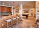 Basement bar area features granite countertops, wood cabinets, and seating for entertaining by the billiard room at 5195 Raintree Cir, Parker, CO 80134
