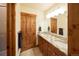 Bathroom featuring double sinks with granite countertops and wooden cabinetry at 5195 Raintree Cir, Parker, CO 80134