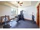 Spacious exercise room with modern equipment and a tray ceiling with ceiling fan at 5195 Raintree Cir, Parker, CO 80134