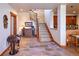 Foyer with stone floors, staircase and adjacent to kitchen and dining at 5195 Raintree Cir, Parker, CO 80134