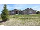 A beautiful home showcasing a well-maintained lawn, stone details, and a welcoming walkway at 5195 Raintree Cir, Parker, CO 80134