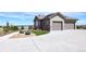 A spacious three-car garage with an extra wide driveway and beautiful landscaping at 5195 Raintree Cir, Parker, CO 80134
