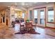 Open concept dining area with French doors, a stone archway, and a cowhide rug on tile flooring at 5195 Raintree Cir, Parker, CO 80134