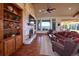 Bright living room with built in bookshelves, wooden beams and a stone fireplace at 5195 Raintree Cir, Parker, CO 80134