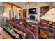 Cozy living room with stone fireplace, hardwood floors, and built-in shelving at 5195 Raintree Cir, Parker, CO 80134