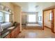 Bright bathroom featuring a soaking tub, walk-in shower, and double vanity at 5195 Raintree Cir, Parker, CO 80134