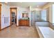 Bright bathroom featuring a walk-in shower, soaking tub, and walk-in closet at 5195 Raintree Cir, Parker, CO 80134
