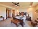 Spacious main bedroom with a seating area, area rug, and a ceiling fan at 5195 Raintree Cir, Parker, CO 80134