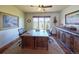 Office space with a large desk, neutral walls, and view of a beautiful landscape at 5195 Raintree Cir, Parker, CO 80134