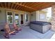 Covered patio featuring a hot tub and comfortable rocking chairs for relaxation at 5195 Raintree Cir, Parker, CO 80134