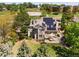 Aerial view of a landscaped home featuring solar panels, patio area, and lush greenery in a suburban setting at 8833 Maplewood Dr, Highlands Ranch, CO 80126