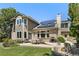 Backyard view showcasing the home's architectural design, patio area, and manicured lawn at 8833 Maplewood Dr, Highlands Ranch, CO 80126