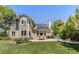 Spacious backyard featuring a well-maintained lawn, patio with dining, and lush landscaping at 8833 Maplewood Dr, Highlands Ranch, CO 80126