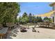 Inviting backyard patio with comfortable seating, a fire pit, and shade sail, ideal for outdoor entertaining at 8833 Maplewood Dr, Highlands Ranch, CO 80126