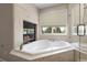 Luxurious bathroom featuring a soaking tub, fireplace and a separate glass shower at 8833 Maplewood Dr, Highlands Ranch, CO 80126