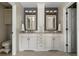 Elegant bathroom featuring double sinks, granite counters, and ample storage at 8833 Maplewood Dr, Highlands Ranch, CO 80126