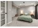 Basement bedroom with a comfortable bed, stylish side tables with lamps, and practical closet storage at 8833 Maplewood Dr, Highlands Ranch, CO 80126