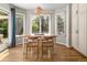 Bright dining area with hardwood floors, a pendant light, and sliding glass doors to the patio at 8833 Maplewood Dr, Highlands Ranch, CO 80126