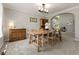 Traditional dining room with carpet, chandelier lighting, and dining table with seating for six at 8833 Maplewood Dr, Highlands Ranch, CO 80126