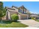 Charming two-story home featuring a brick and siding facade, a three-car garage, and mature landscaping at 8833 Maplewood Dr, Highlands Ranch, CO 80126