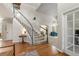 Bright foyer with hardwood floors, a staircase, soaring ceilings and an open view to the living area at 8833 Maplewood Dr, Highlands Ranch, CO 80126
