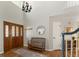 Foyer with hardwood floors, a staircase, overhead lighting, and a bench perfect for a mudroom at 8833 Maplewood Dr, Highlands Ranch, CO 80126