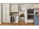 Kitchen showcases custom cabinets, stainless steel appliances, wine storage, and hardwood flooring at 8833 Maplewood Dr, Highlands Ranch, CO 80126