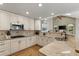 Bright kitchen featuring granite countertops, white cabinets, stainless steel appliances, and wood floors at 8833 Maplewood Dr, Highlands Ranch, CO 80126