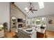 Bright and airy living room with a striking brick fireplace, skylights, and a comfortable sectional sofa at 8833 Maplewood Dr, Highlands Ranch, CO 80126