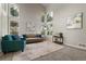 Spacious living room with soaring ceilings, large windows offering natural light and comfortable seating at 8833 Maplewood Dr, Highlands Ranch, CO 80126