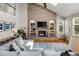 Inviting living room features a floor-to-ceiling brick fireplace, vaulted ceilings, and comfortable seating at 8833 Maplewood Dr, Highlands Ranch, CO 80126