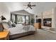 Comfortable main bedroom features a cozy fireplace and bay window for ample natural light at 8833 Maplewood Dr, Highlands Ranch, CO 80126