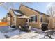 Backyard patio with an outdoor dining table and chairs, perfect for entertaining, snow on the ground at 16102 Grebe Pl, Parker, CO 80134