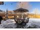 Outdoor patio is furnished with seating, a dining table, and umbrella, creating a great relaxation area at 16102 Grebe Pl, Parker, CO 80134