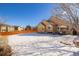 A view of the backyard shows the layout, fencing and patio area, with snowy ground at 16102 Grebe Pl, Parker, CO 80134