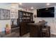 Basement wet bar complete with barstools and a beverage fridge, great for entertaining at 16102 Grebe Pl, Parker, CO 80134