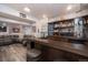 Basement bar area featuring stools and a couch, perfect for entertaining guests at 16102 Grebe Pl, Parker, CO 80134