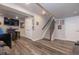 Finished basement with wood floors, staircase, and a comfortable seating arrangement at 16102 Grebe Pl, Parker, CO 80134