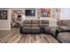 Finished basement featuring wood floors, a comfortable seating arrangement, and workout equipment at 16102 Grebe Pl, Parker, CO 80134