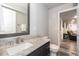 Bathroom featuring a granite countertop with a brushed nickel faucet and dark wood cabinets at 16102 Grebe Pl, Parker, CO 80134