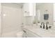 A clean bathroom featuring a shower-tub combo, white tile, and marble countertop at 16102 Grebe Pl, Parker, CO 80134