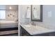 Modern bathroom featuring gray cabinets, marble countertops, sink and a mirror at 16102 Grebe Pl, Parker, CO 80134