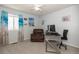 Bright bedroom with beach-themed decor, comfortable seating, and a dedicated workspace at 16102 Grebe Pl, Parker, CO 80134